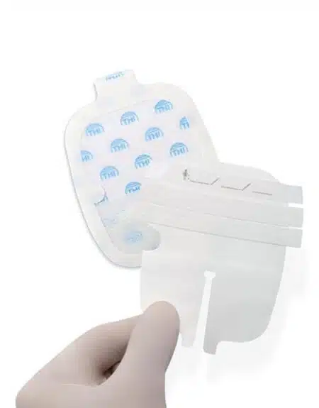 a hand holding a white and blue gauze